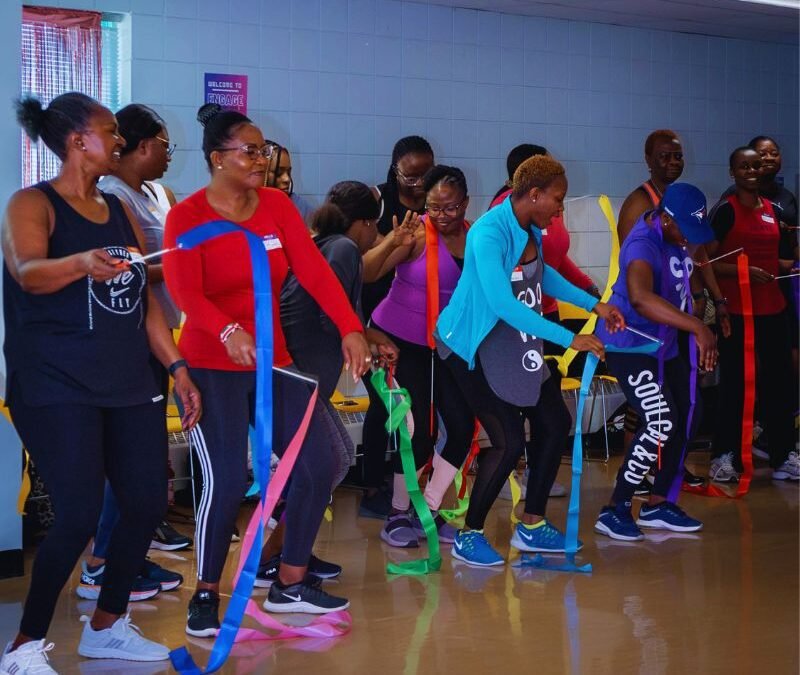 women with ribbons dancing with athletic gear on